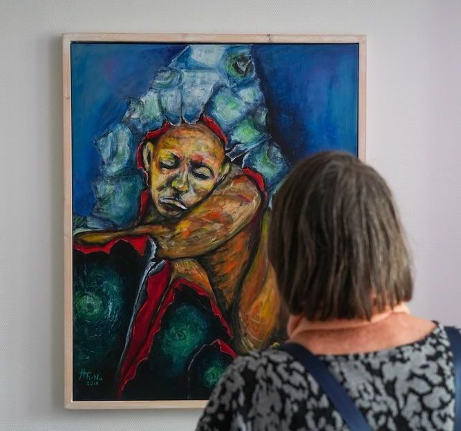 Blick über die Schulter einer Person, die gerade ein Gemälde betrachtet.