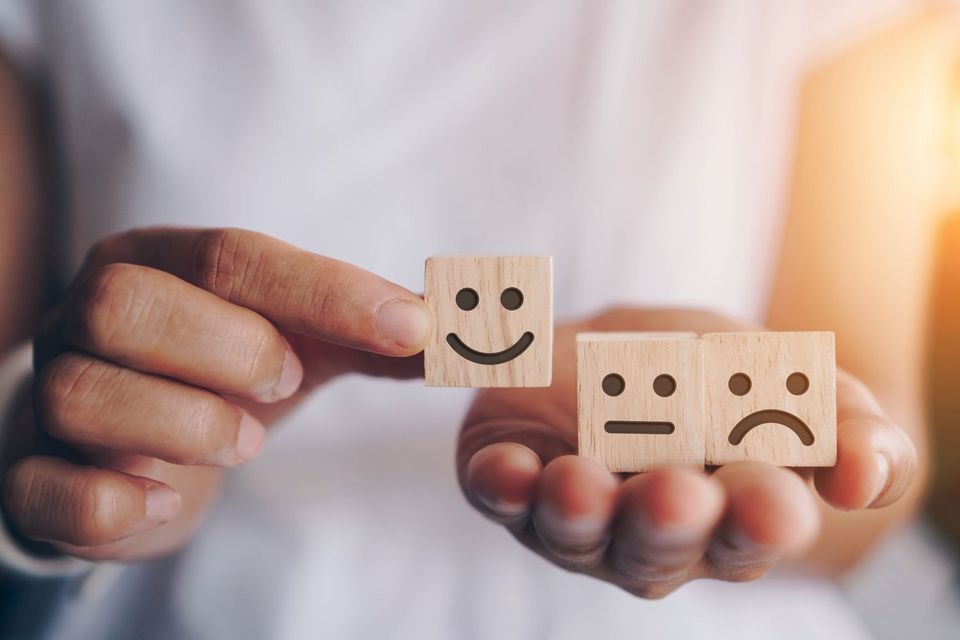 Smile face and cart icon on wood cube. Optimistic person or peop